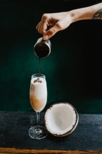 Food photography in natural light. Cocktail with rum, coconut and coffee served in an asian restaurant.