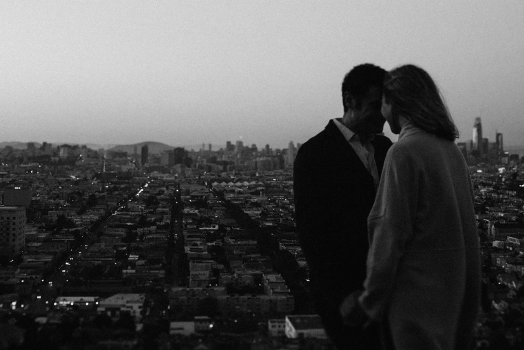 Black and white wedding photograph in San Francisco. Moody feel, sunset and city lights